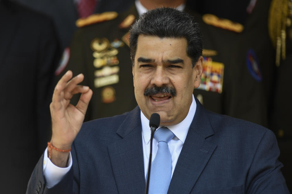 FILE - In this March 12, 2020 file photo, Venezuelan President Nicolas Maduro speaks during a press conference at the Miraflores Presidential Palace in Caracas, Venezuela. The political battle over control of Venezuela has turned to a $1 .8 billion stack of gold bars sitting in the Bank of England's vault in London, where a judge is expected to decide soon on who has the rightful claim to the bullion. Maduro says he needs the gold to help his cash-starved nation fight the coronavirus pandemic. But the central bank for the United Kingdom, whose government recognizes opposition leader Juan Guaido as his country's legitimate leader, has refused to hand it over to Maduro's socialist administration. (AP Photo/Matias Delacroix, File)