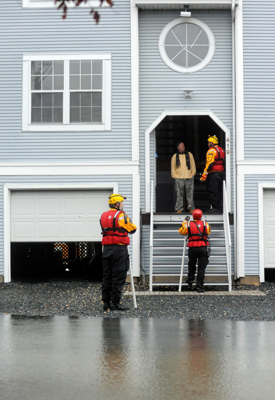 Harford County, Md., rescue team members alert a resident to a voluntary evacuation plan as a tidal surge rises in the aftermath of superstorm Sandy, Tuesday, Oct. 30, 2012 in Havre de Grace, Md. (AP Photo/Steve Ruark)