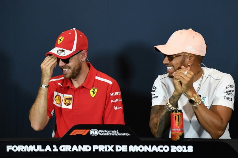 It's a secret: Sebastian Vettel and Lewis Hamilton are all smiles at a press conference in Monaco on Wednesday