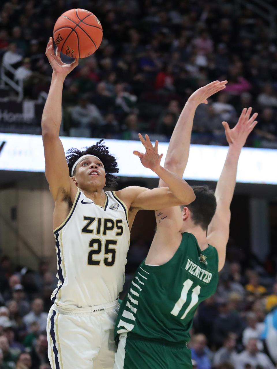 Akron's Enrique Freeman (25) shoots over Ohio's Gabe Wiznitzer (11) in the semifinals of the Mid-American Conference Tournament on Friday in Cleveland.