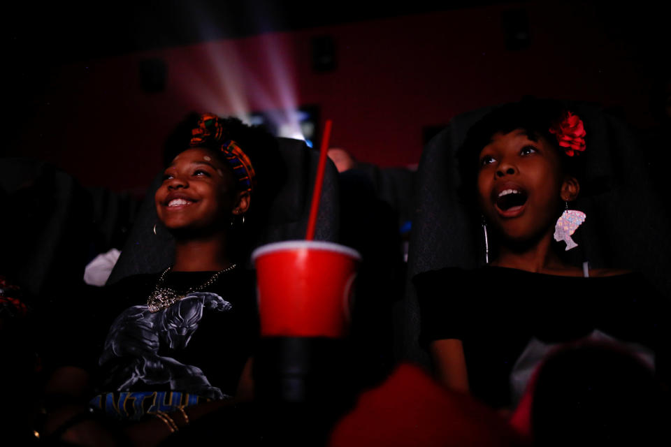 Sixth-graders Destiny Cox, left, and Allana Walker watch the film.