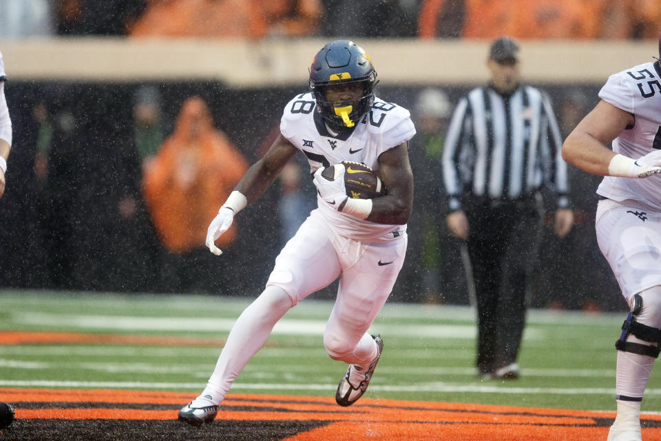 West Virginia running back Jaylen Anderson (28) runs with the ball during the second half of the NCAA college football game against Oklahoma State in Stillwater, Okla., Saturday Nov. 26, 2022. (AP Photo/Mitch Alcala)