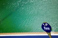 2016 Rio Olympics - Water Polo - Preliminary - Men's Preliminary Round - Group A Australia v Japan - Maria Lenk Aquatics Centre - Rio de Janeiro, Brazil - 10/08/2016. An International Swimming Federation (FINA) sign is seen in front of the Aquatics Centre pool where the water turned green. REUTERS/Kai Pfaffenbach