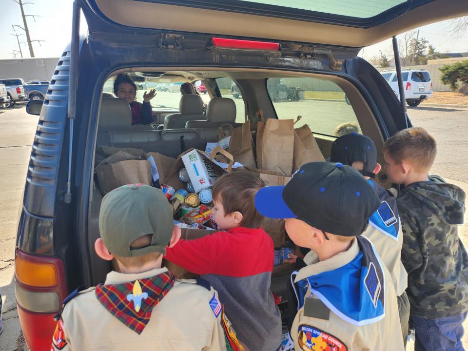 Area Boy Scout troops work to deliver food donations to the High Plains Food Bank Distribution Center on Saturday morning during this year's Scouting for Food drive.