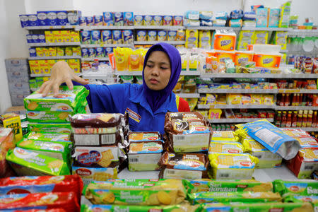 A shopkeeper arranges snacks to sell at a mini market in Jakarta, Indonesia, February 15, 2019. REUTERS/Willy Kurniawan