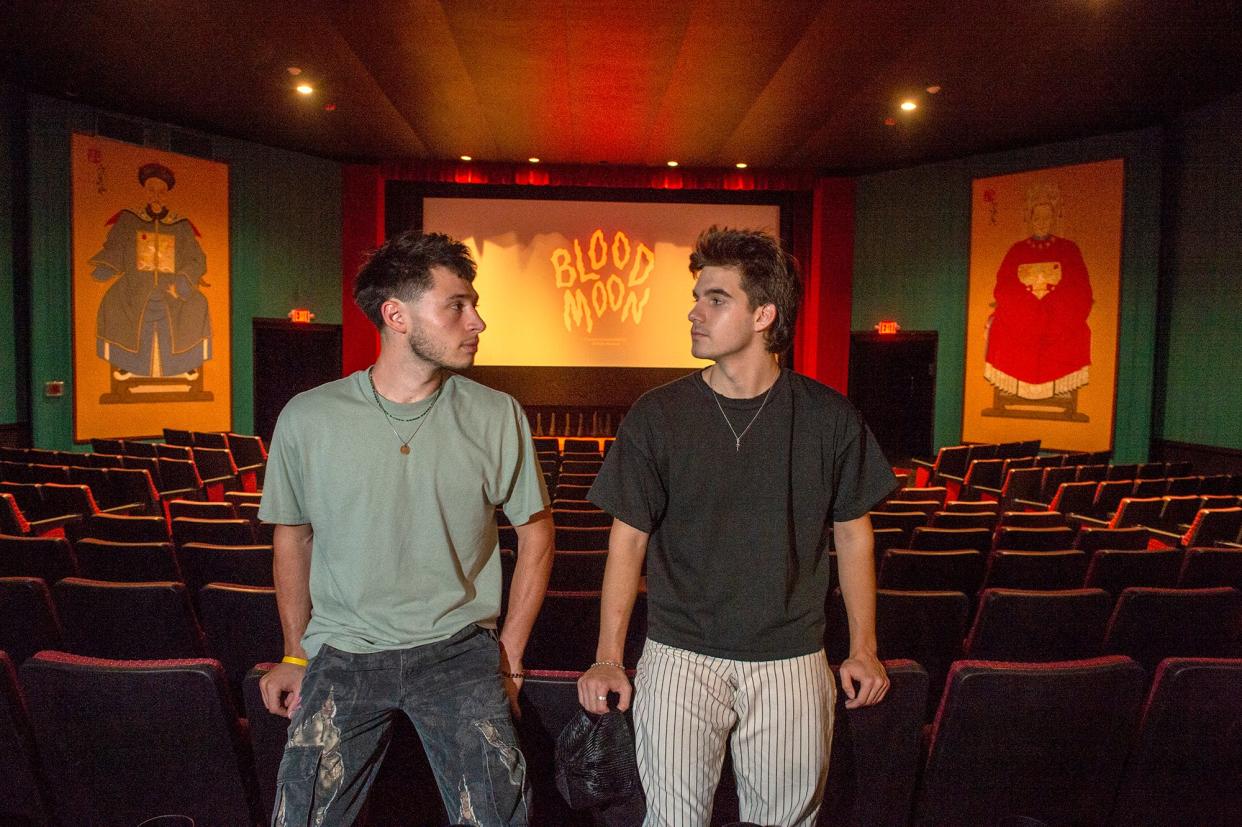Ethan Charles, left, and Caleb Spilios, pictured in the Maynard Fine Arts Theatre, Aug. 5, 2022. Their new film, "Blood Moon," premieres there at noon on Sunday.