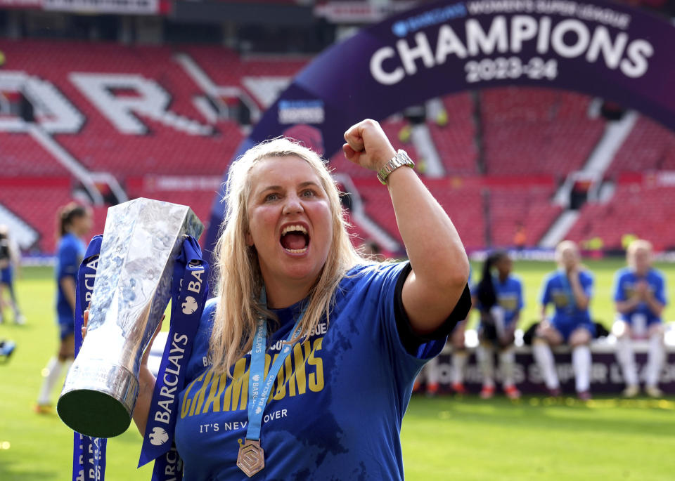 Chelsea manager Emma Hayes celebrates with the trophy after winning the English Women's Super League soccer match between Manchester United and Chelsea at Old Trafford, in Manchester, England, Saturday, May 18, 2024. (Martin Rickett/PA via AP)