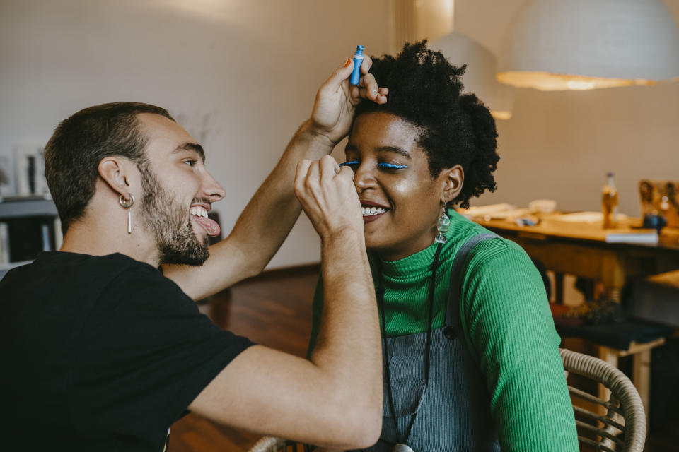 A friend doing another friend's makeup