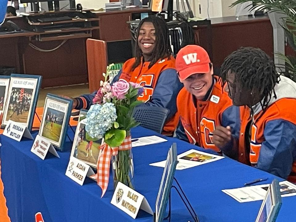 The journey didn't stop at region finals for Palm Beach Gardens football players Desean Butler, Brand Campbell and Aidan Parker. The trio put pen to paper in a Tuesday signing ceremony at Palm Beach Gardens High to confirm where they'll spend the next few years.