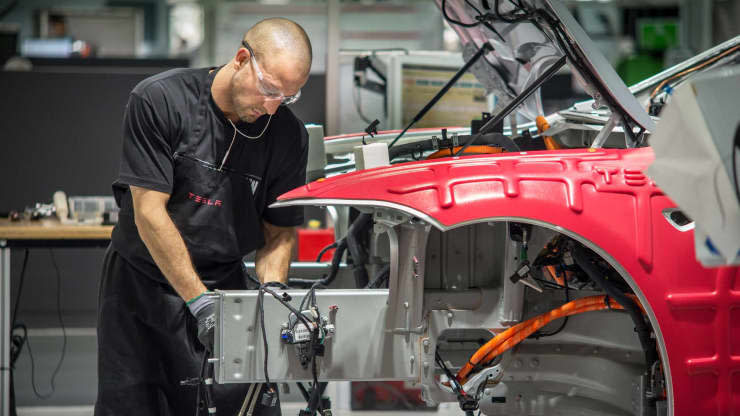 Workers assemble cars on the line at the Tesla’s factory in Fremont, California (Getty Images)