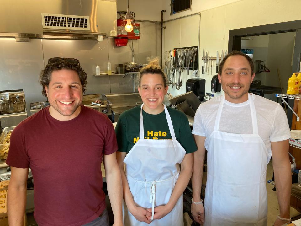 Maudite Poutine owners Michael, Leah and Joe Collier stand in the kitchen of the Burlington restaurant May 20, 2022.