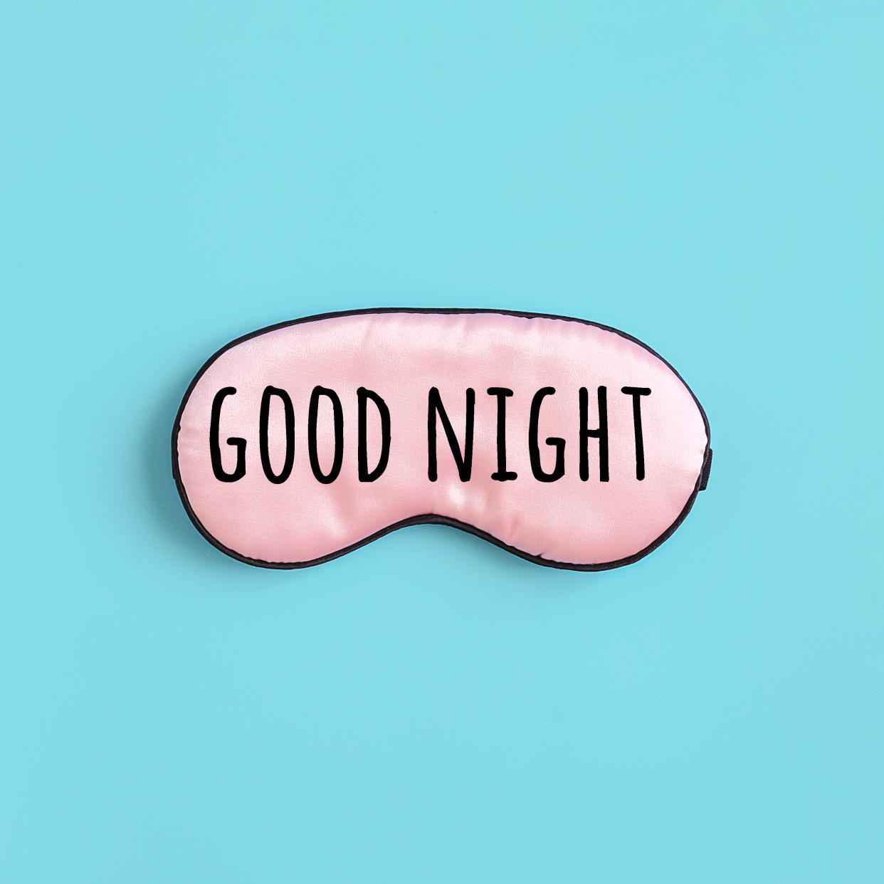 A photo of a sleep mask. Printed on it are the words: Good night.