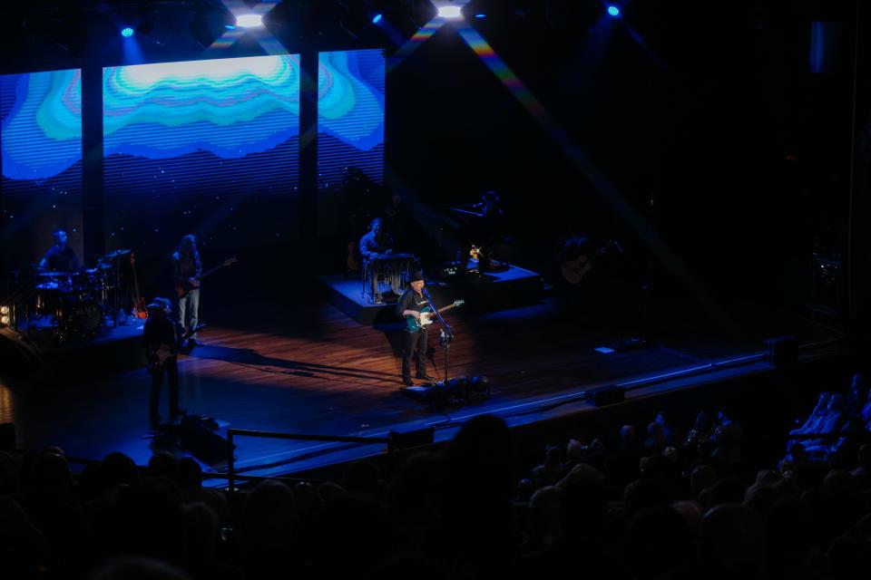 Clint Black singing and playing guitar on the Ryman stage, Feb. 2024