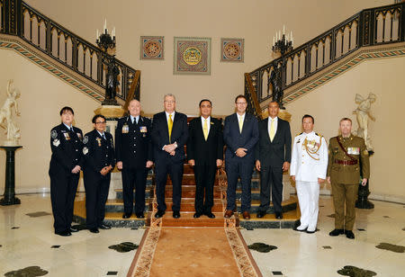 Thailand's Prime Minister Prayuth Chan-ocha (C), Richard Harris (C-R) and Craig Challen (3RD-R), Australian members of the Thai cave rescue team pose for a photo after receiving the Member of the Most Admirable Order of the Direkgunabhorn award at the Government House, in Bangkok, Thailand, April 19, 2019. Thailand Government House/Handout via REUTERS