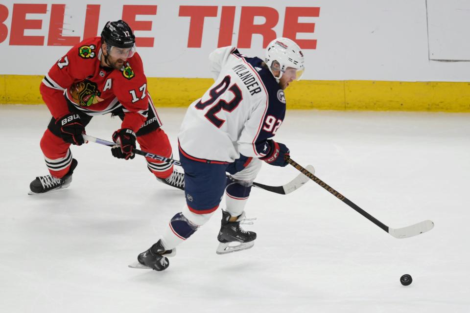 Columbus Blue Jackets' Alexander Nylander (92) moves the puck against Chicago Blackhawks' Nick Foligno (17) during the first period of an NHL hockey game Saturday, March 2, 2024, in Chicago. (AP Photo/Paul Beaty)