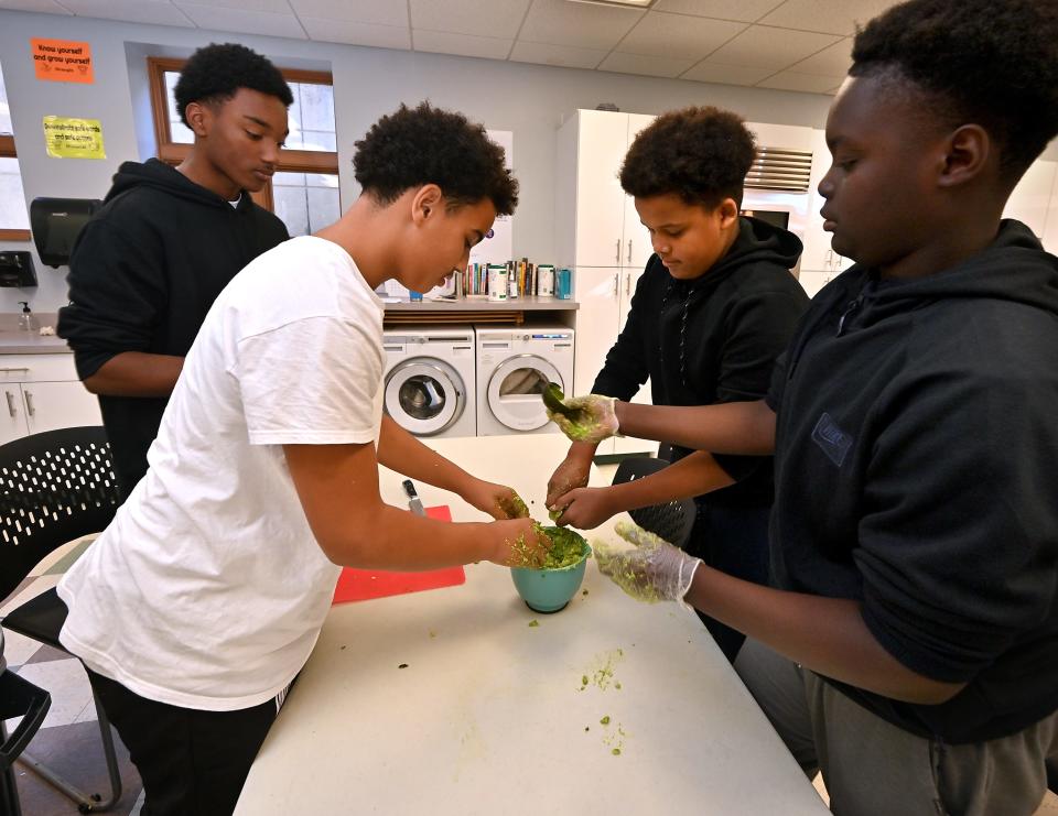 Nativity School of Worcester eighth grade boys prepare guacamole on Friday as part of the school's Hispanic Heritage Month celebration.