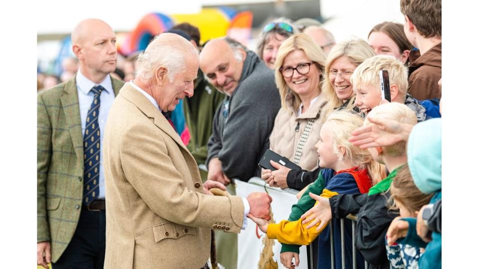 King Charles shaking hands with a crowd