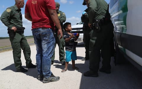  A boy and father from Honduras are taken into custody - Credit: Getty