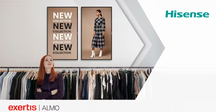 A woman stands in front of digital signage in a women's clothing store.