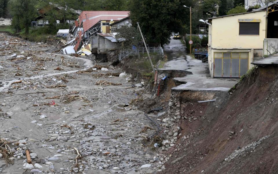 A damaged road and houses in Roquebilliere, south-eastern France - AFP