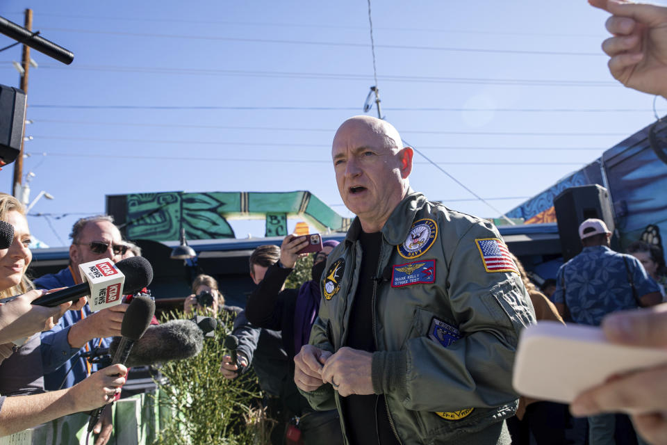 Sen. Mark Kelly, D-Ariz., speaks to the media at the Barrio Cafe in Phoenix, Saturday, Nov. 12, 2022. (AP Photo/Alberto Mariani)