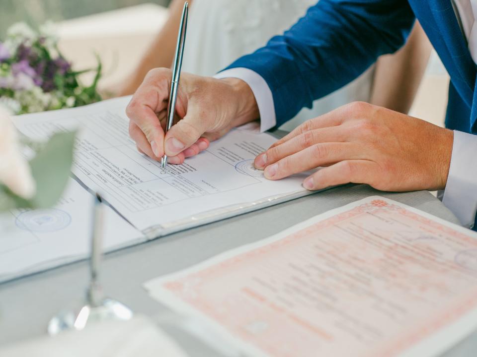 A couple signing a marriage license