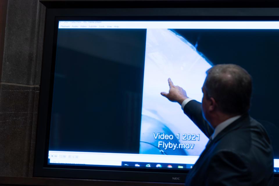 Deputy Director of Naval Intelligence Scott Bray points to a video display of a UAP during a hearing of the House Intelligence, Counterterrorism, Counterintelligence, and Counterproliferation Subcommittee hearing on "Unidentified Aerial Phenomena," on Capitol Hill, Tuesday, May 17, 2022.