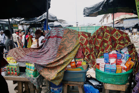 A street vendor sells illegal and false drugs in a street of Adjame in Abidjan, Ivory Coast October 13, 2018. Picture taken October 13, 2018. REUTERS/Luc Gnago