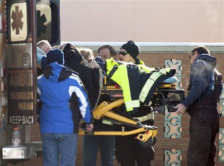 Members of a family that went missing are wheeled by stretcher from an ambulance into the Pershing General Hospital in Lovelock, Nevada, December 10, 2013. REUTERS/James Glover