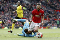 Manchester United's Bruno Fernandes is brought down in the penalty area by Watford goalkeeper Ben Foster, during their English Premier League soccer match at Old Trafford in Manchester, England, Sunday Feb. 23, 2020. Fernandes went on to score from the penalty spot. (Martin Rickett/PA via AP)