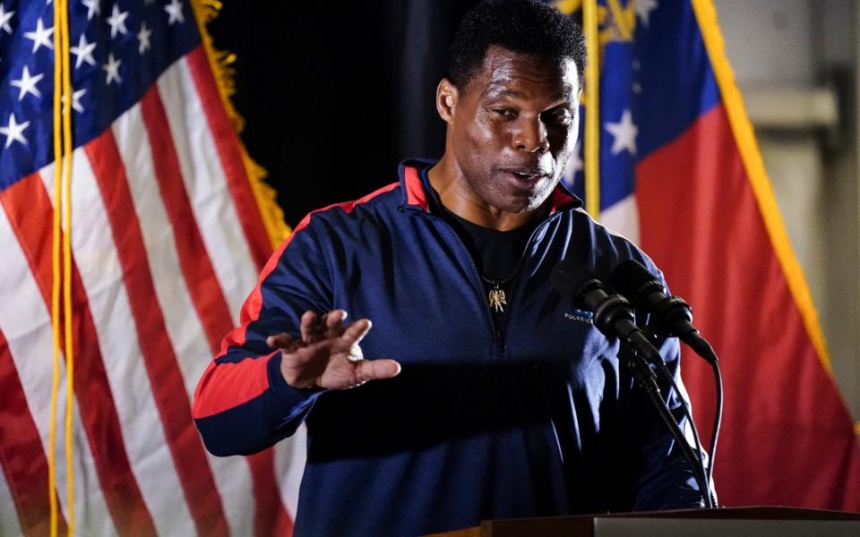 Herschel Walker is backed by Donald Trump - John Bazemore/AP