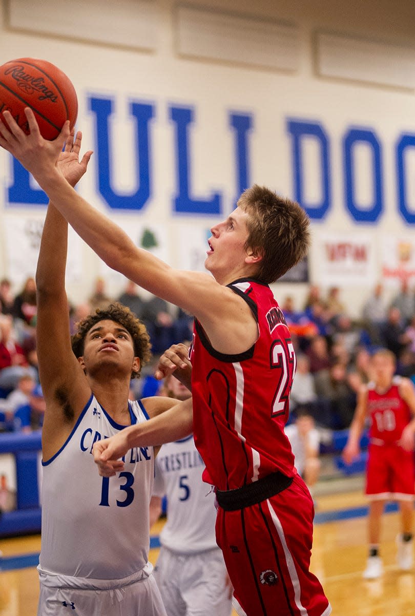 Bucyrus' Malachi Bayless lays up a shot around Crestline's Isaiah Perry.