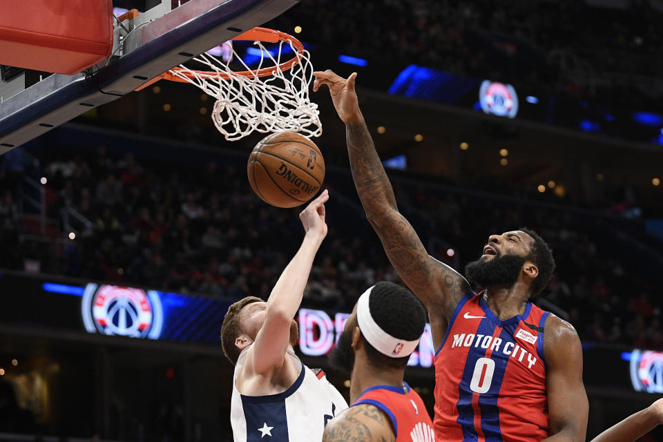 Detroit Pistons center Andre Drummond (0) dunks over Washington Wizards forward Davis Bertans, left, during the first half of an NBA basketball game, Monday, Jan. 20, 2020, in Washington. (AP Photo/Nick Wass)