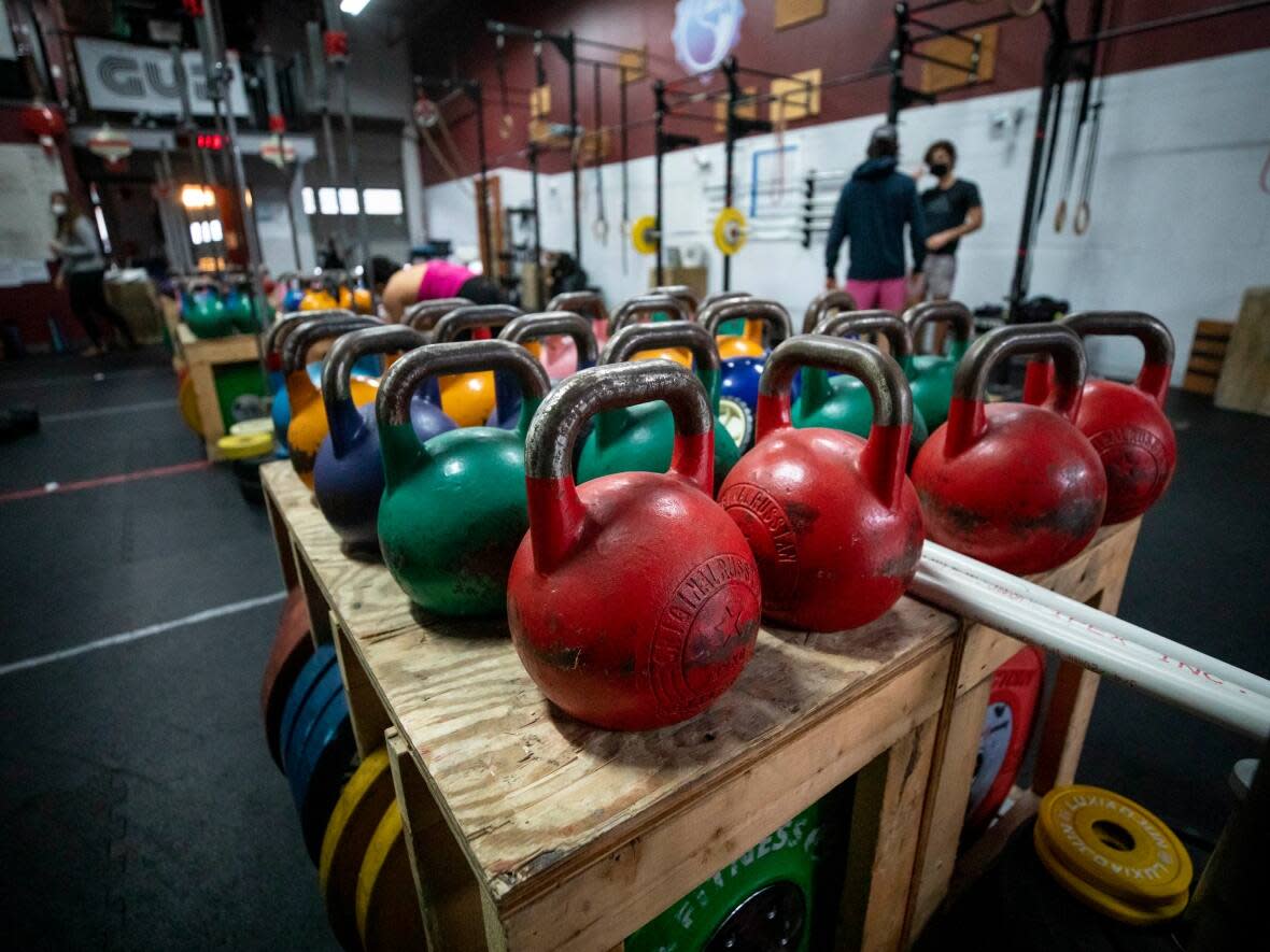 People are pictured working out at Engineered Bodies Strength & Conditioning fitness gym hours before restrictions will take place in Port Moody, British Columbia on Wednesday, December 22, 2021.  (Ben Nelms/CBC - image credit)
