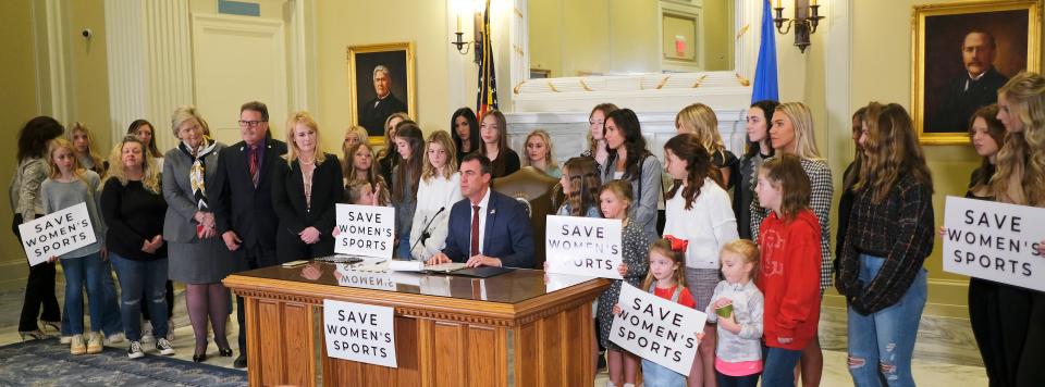 Gov. Kevin Stitt signs Senate Bill 2, which bans transgender women from competing in women's sports at Oklahoma schools, during a ceremony Wednesday at the state Capitol.