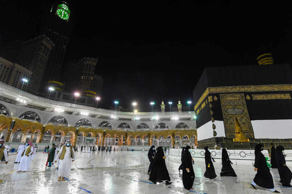 In this photo released by the Saudi Media Ministry, officials prepare for the arrival of pilgrims Wednesday, July 29, 2020, in Mecca, Saudi Arabia, by simulating the first rites of hajj around Islam’s holiest site, the Kaaba, hours before the pilgrimage is set to begin. The Islamic pilgrimage has been drastically downsized from 2.5 million pilgrims to as little as 1,000 this year due to the global coronavirus pandemic. pilgrimage has been dramatically downsized. (Saudi Media Ministry via AP)