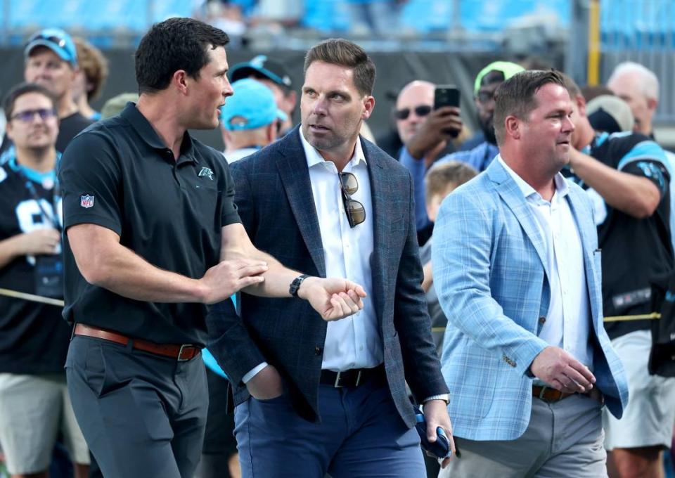 Former Carolina Panthers linebacker Luke Kuechly, left, speaks with team assistant general manager Dan Morgan, center, as team general manager Scott Fitterer, right, looks on at Bank of America Stadium on Monday, September 18, 2023. The Panthers host the New Orleans Saints in NFL action at Bank of America Stadium.