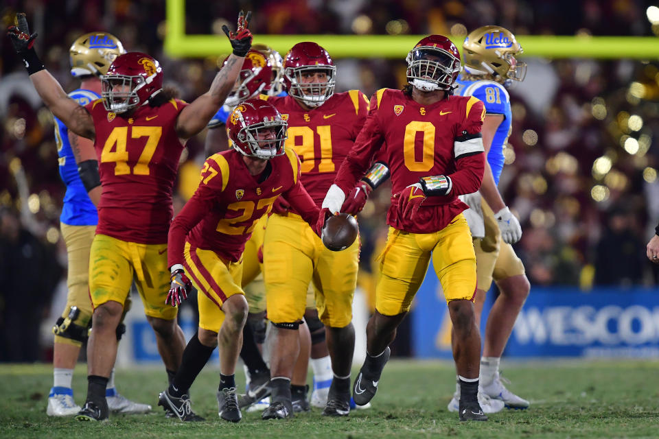 Nov 19, 2022; Pasadena, California, USA; Southern California Trojans defensive end <a class="link " href="https://sports.yahoo.com/ncaaf/players/326869" data-i13n="sec:content-canvas;subsec:anchor_text;elm:context_link" data-ylk="slk:Korey Foreman;sec:content-canvas;subsec:anchor_text;elm:context_link;itc:0">Korey Foreman</a> (0) celebrates after an interception against the UCLA Bruins during the second half at the Rose Bowl. Mandatory Credit: Gary A. Vasquez-USA TODAY Sports