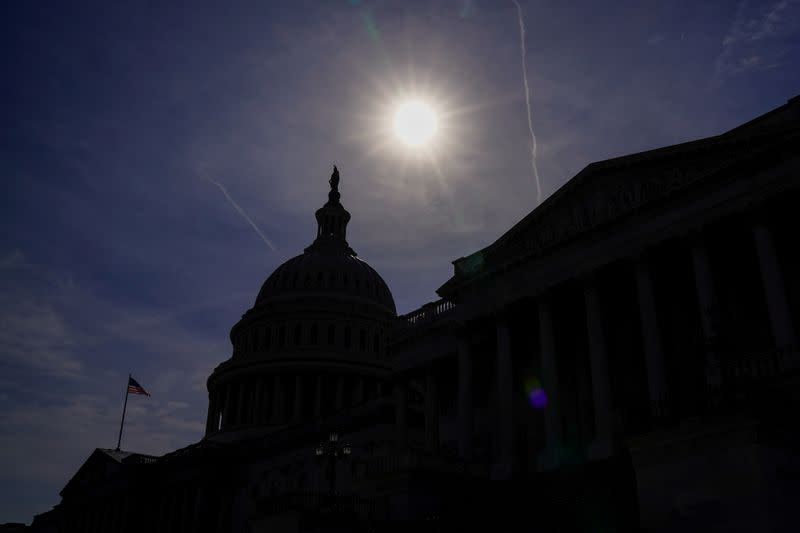 The U.S. Capitol is silhouetted by the sun in Washington