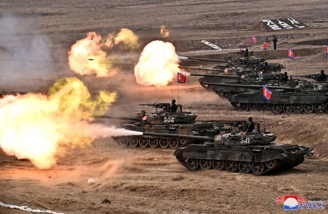 North Korea's Kim 'drives' new tank during mock battle