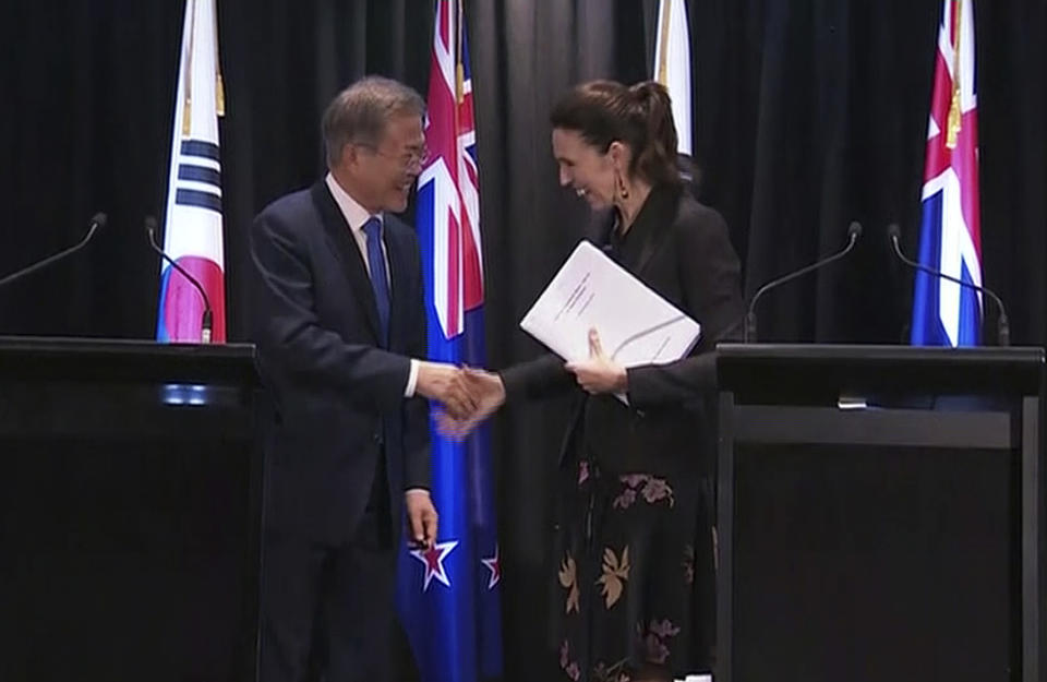 In this image made from a video, New Zealand's Prime Minister Jacinda Ardern, right, and South Korean President Moon Jae-in shake hands after their joint news conference in Auckland, New Zealand Tuesday, Dec. 4, 2018. Ardern says New Zealand will soon allow smoother immigration procedures for visitors from South Korea and plans to improve pension portability between the two countries. (NZ POOL via AP)