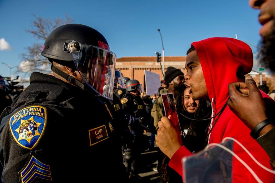 California Highway Patrol Sgt. Ron Wade is berated on March 23, 2018, by angry protesters following the shooting death of Stephon Clark by Sacramento Police officers. 