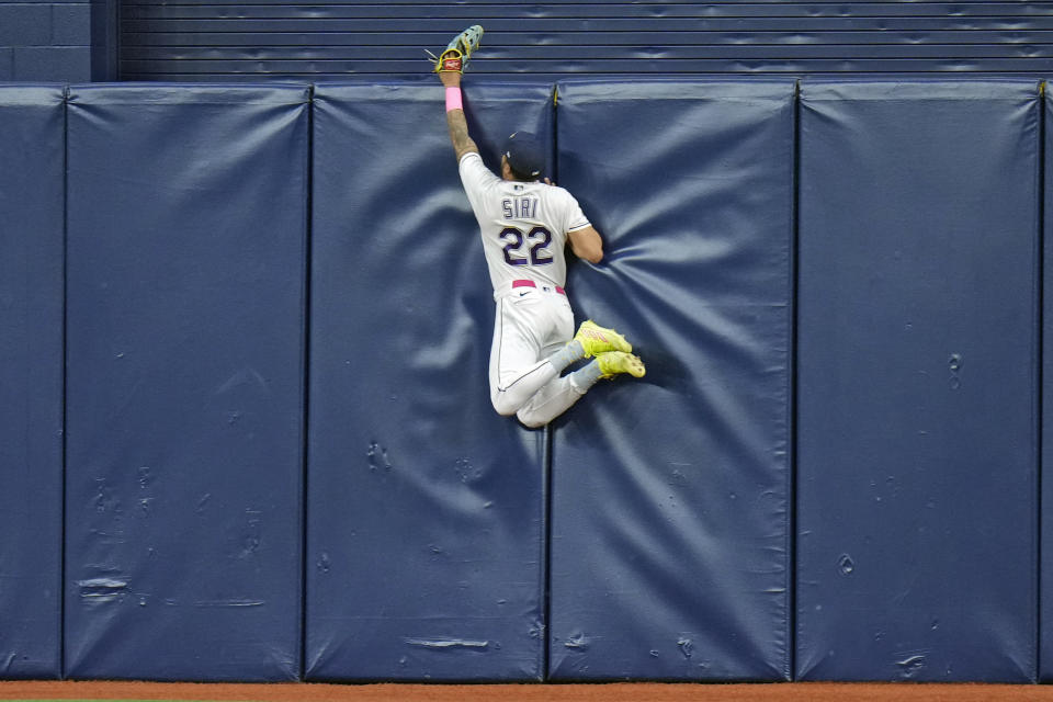 Tampa Bay Rays center fielder Jose Siri (22) leaps high but can't make the catch on a solo home run by Seattle Mariners' Cal Raleigh during the fifth inning of a baseball game Friday, Sept. 8, 2023, in St. Petersburg, Fla. (AP Photo/Chris O'Meara)