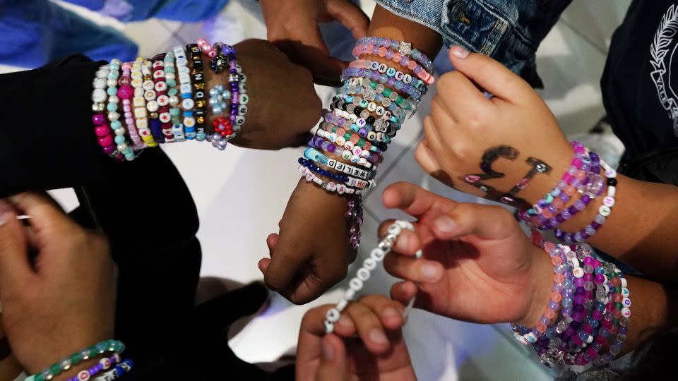 Teenagers trade bracelets while waiting for the beginning of Taylor Swift's Eras Tour concert movie in a cinema in Mexico City, Mexico October 13, 2023.  - Alexandre Meneghini/Reuters