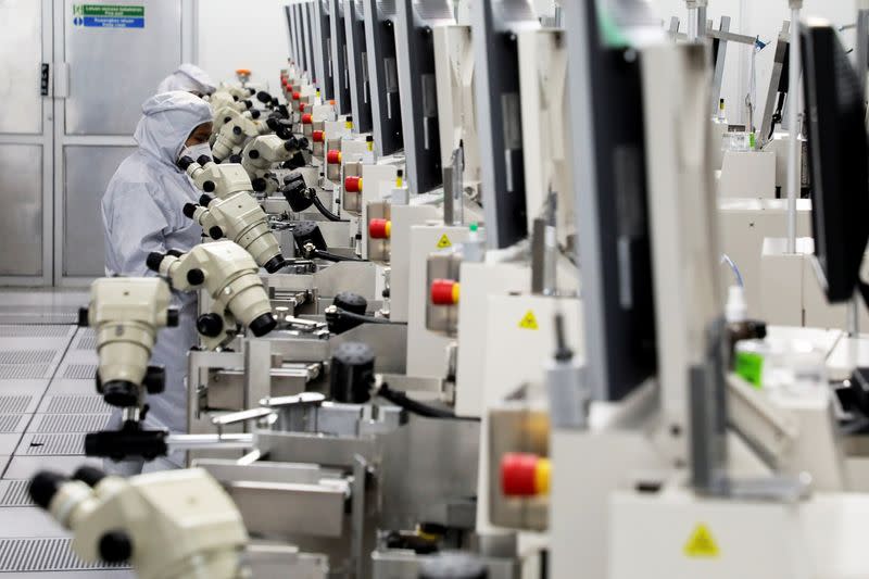 Workers monitor operations at the chip packaging firm Unisem (M) Berhad plant in Ipoh