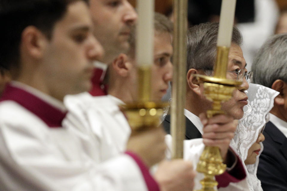 South Korean President Moon Jae-in, right, sits inside St. Peter's Basilica for a Mass for Peace celebrated by Vatican Secretary of State Pietro Parolin at the Vatican, Wednesday, Oct. 17, 2018. South Korea's president is in Italy for a series of meetings that will culminate with an audience with Pope Francis at which he's expected to extend an invitation from North Korean leader Kim Jong Un to visit. (AP Photo/Gregorio Borgia)