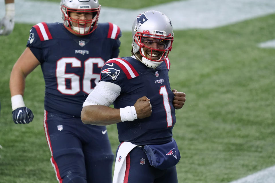 New England Patriots quarterback Cam Newton, right, celebrates his touchdown catch of a pass thrown by wide receiver Jakobi Meyers as offensive lineman James Ferentz (66) joins him during the second half of an NFL football game against the New York Jets, Sunday, Jan. 3, 2021, in Foxborough, Mass. (AP Photo/Elise Amendola)