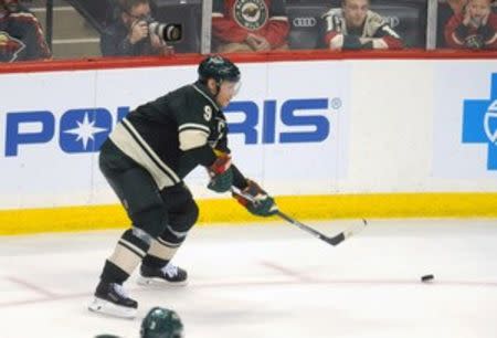 Apr 24, 2016; Saint Paul, MN, USA; Minnesota Wild center Mikko Koivu (9) passes the puck behind the Stars net during the third period Minnesota Wild Dallas Stars in game six of the first round of the 2016 Stanley Cup Playoffs at Xcel Energy Center. Marilyn Indahl-USA TODAY Sports