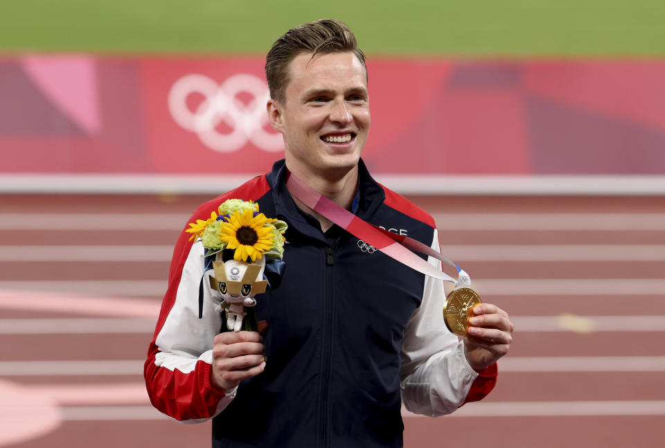 Karsten Warholm of Norway shows off gold medal