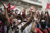 Demonstrators gesture during a protest against Tunisian President Kais Saied, Saturday, Sept. 18, 2021 in Tunis. In July Tunisian President Kais Saied fired the country's prime minister and froze parliament's activities after violent demonstrations over the country's pandemic and economic situation. The movement made by Saied was considered by his opponents as a coup. (AP Photo/Riadh Dridi)